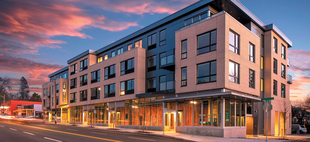 Exterior view of The Marilyn, a multi‑use building off Hawthorne Boulevard in Portland, Oregon with apartments and retail space, featuring branding design created by Priscilla Creative, a Portland, Oregon design agency.